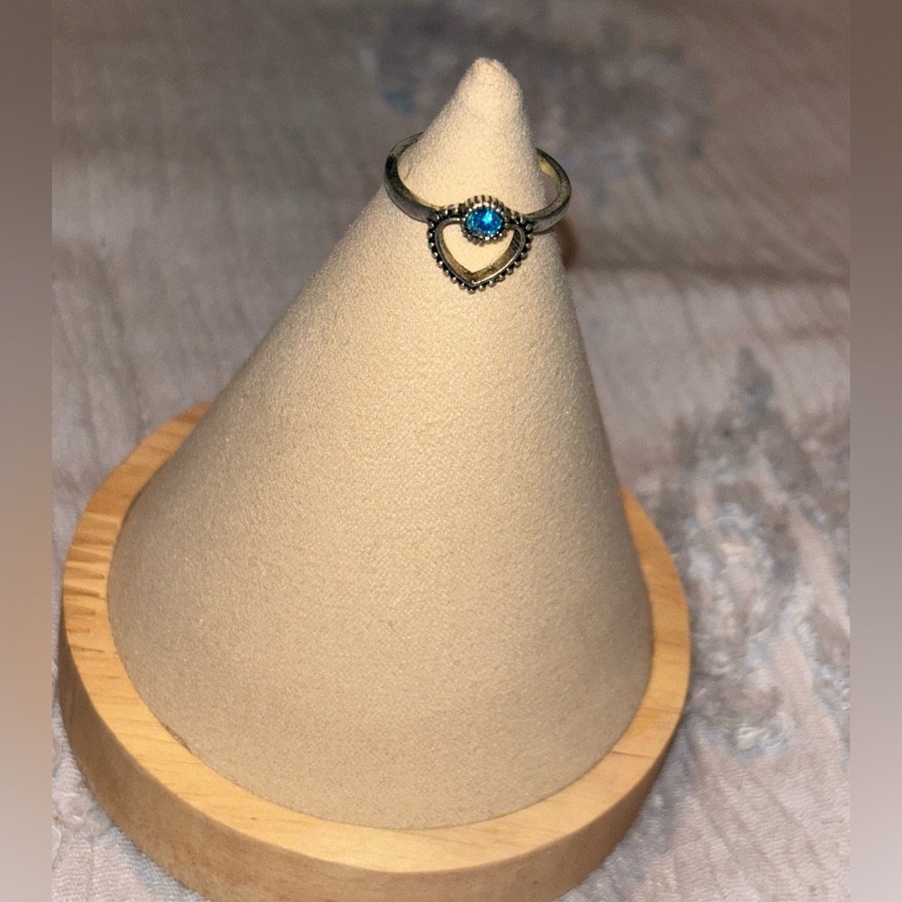 Silver ring with heart design & blue stone
Size 8